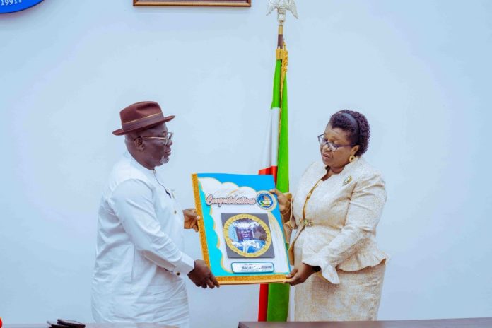 Delta State Governor, Rt. Hon. Sheriff Oborevwori (left) presented with a life-size congratulatory card for his successful and impactful one year in office, by the Chairman, Forum of Female Permanent Secretaries in the State Civil Service and Permanent Secretary, Ministry of Environment, Dr. (Mrs.) Minnie Oseji, when she led the group on a courtesy visit to the Governor PIX: SAMUEL JIBUNOR