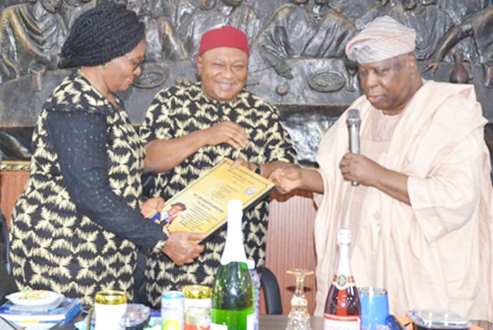 Pro-Chancellor and Chairman of DELSU Governing Council, Gen. Alexander Ogomudia (rtd), presenting gifts to outgoing VC of DELSU, Prof Andy Ogochukwu Egwunyenga, and his wife, Prof. (Mrs.) Joyce Ebele Egwunyenga, on behalf of council, during a special council meeting in honour of Egwunyenga