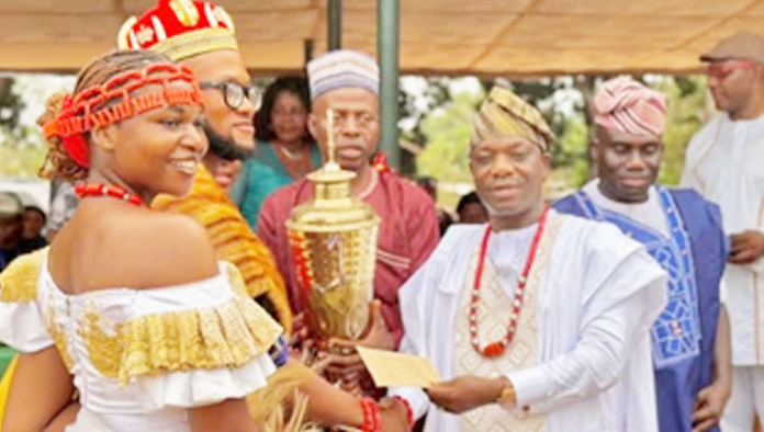 Presentation of the trophy to winners of the NYSC Cultural Carnival by the Delta State NYSC Coordinator, Mr. John Vandi Kwaghe, at the Permanent Orientation Camp, Issele-Uku.