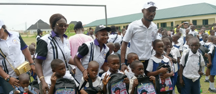 The president and founder of Ernest Bebenimibo Foundation, Deacon Ernest Bebenimibo, and his team with the pupils of Okerenkoko Primary schools in Warri South West Local Government Area, Delta state